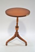 An Edwardian satinwood tripod occasional table, on turned pedestal on splayed legs with spade feet,