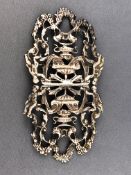 A silver Rococo style two piece belt buckle decorated with urns, cherubs and floral swags,