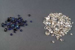 A collection of loose stones to include sapphire. Blue topaz and cubic zirconia.