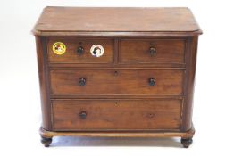 A Victorian mahogany chest of two short and two long drawers, with turned handles, on turned feet,