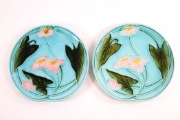 A pair of 19th century majolica turquoise glazed plates decorated with waterlillies