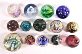 A collection of fourteen various glass paperweights, mainly of abstract design, including Caithness,