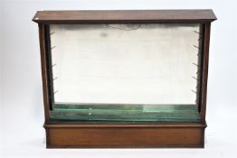A mahogany standing glazed cabinet, with glass shelves, and mirrored back, 92cm high, 115cm wide,