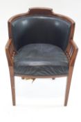 An Edwardian mahogany tub shaped chair with leatherette back and seat on square tapering legs,
