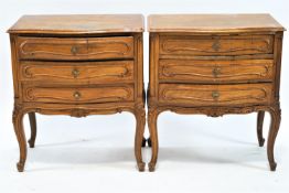A pair of mahogany French style, bedside chests of three drawers on cabriole legs,