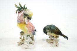 A Karl Ens porcelain figure of a parrot, 19cm high and another of a finch, 9cm high,