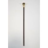 A walking cane in hardwood set a brass pig head handle,