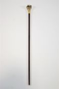 A walking cane in hardwood set a brass pig head handle,