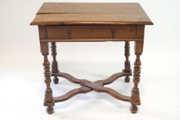 A nineteenth century walnut side table, with one freeze drawer on turned legs,