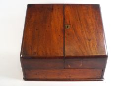 A Victorian stationery box in mahogany with two door sloping front