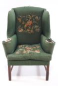 A Gainsborough style wingback armchair on mahogany legs, 122cm high, 90cm wide,