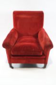 A red velvet armchair on square tapering mahogany legs with brass and ceramic casters, 88cm high,