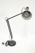 A black anglepoise lamp,