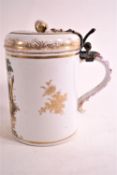 A 19th century Meissen style porcelain tankard and hinged cover,