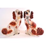 Two pairs of Staffordshire pottery dogs, one pair picked out in gilt, the other in iron red enamels,