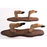 A pair of deer hoof whip racks, mounted on shaped oak boards,