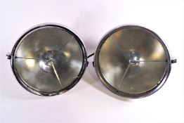 A pair of chrome finish Lucas car headlights,