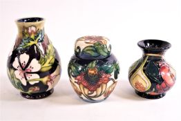 Three pieces of Moorcroft : A ginger jar decorated with tiger lilies,