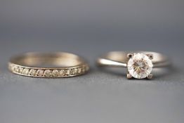 A selection of two white metal rings,