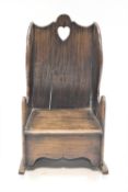 A child's provincial hardwood settle style rocking chair with solid sides and back