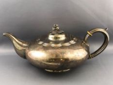A silver low form plain teapot with domed lid set a cast 3D floral finial and set a silver handle