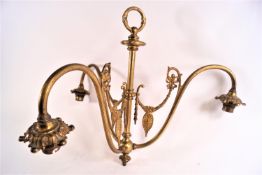 An Edwardian brass three branch ceiling light with ring top leading to a central baluster rod