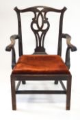 A George III mahogany elbow chair with pierced interlinked splat,