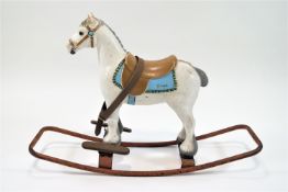 A Triang rocking horse, with moulded integral bridle and saddle, 58cm high, 68cm long,