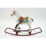 A Triang rocking horse, with moulded integral bridle and saddle, 58cm high, 68cm long,
