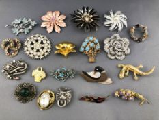 A collection of twenty brooches of variable designs. Finished in base metals and paste stones.