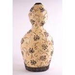 An Art pottery earthenware double gourd vase, glazed in cream,