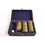 A boxed set of 18th century Spade guinea style brass gaming counters,