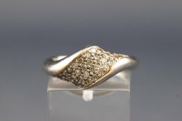 A white metal abstract design ring set with thirty four round brilliant cut diamonds