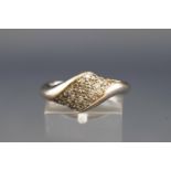 A white metal abstract design ring set with thirty four round brilliant cut diamonds