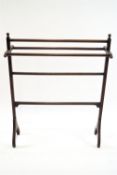 An early 20th century mahogany towel rail with square supports on outswept feet, 105cm high,