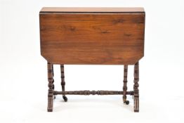 An Edwardian mahogany Sutherland table on turned legs linked by a stretcher,