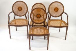 A set of four Edwardian chairs each with round caned and marquetry backs,