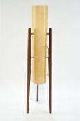 A teak three leg floor light with fibre glass shade,