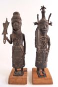 Two Nigerian twentieth century Benin cast bronze figures representing an Uzama ...