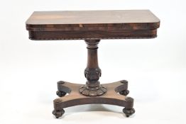A William IV rosewood card table on turned and carved pedestal with shaped rectangular base