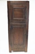 An 18th century oak French cupboard, the two panelled doors now joined as one, 180cm high,