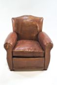 A brown leather armchair, with loose cushion, on block feet, 83cm high, 77cm wide,