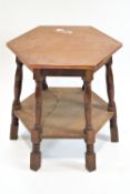 An oak pub table with hammered copper top on turned legs, supported by an under tier, 65cm high,