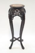 A 19th century Asian carved hardwood plant stand raised on four stretchered cabriole legs