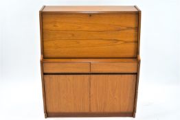 A Remploy teak fall front bureau opening to reveal a pigeon hole interior