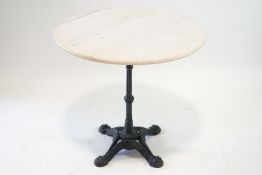 A marble topped table on a four footed cast iron base, 73cm high,