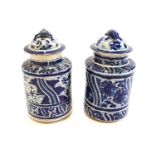 A pair of Puebla tin glazed earthenware cylindrical vases and covers with tortoise finials,