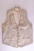 A gentleman's 19th century silver brocade waistcoat with shawl collar and five fabric button front