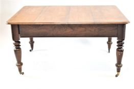 A Victorian mahogany dining table on turned legs with brass casters, 76cm high, 115cm wide,