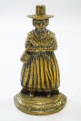 A brass door stop, in the form of a lady in Welsh National costume,